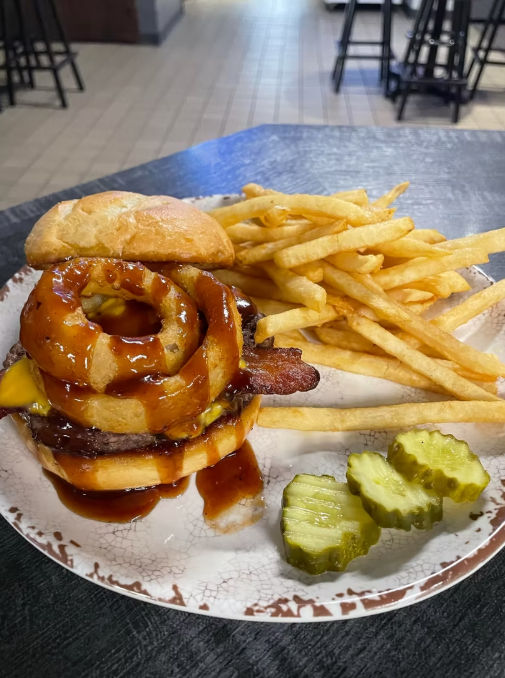 Cheeseburger with onion rings and BBQ sauce