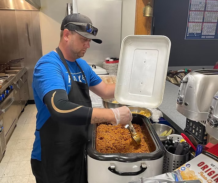 Cook preparing food in the kitchen
